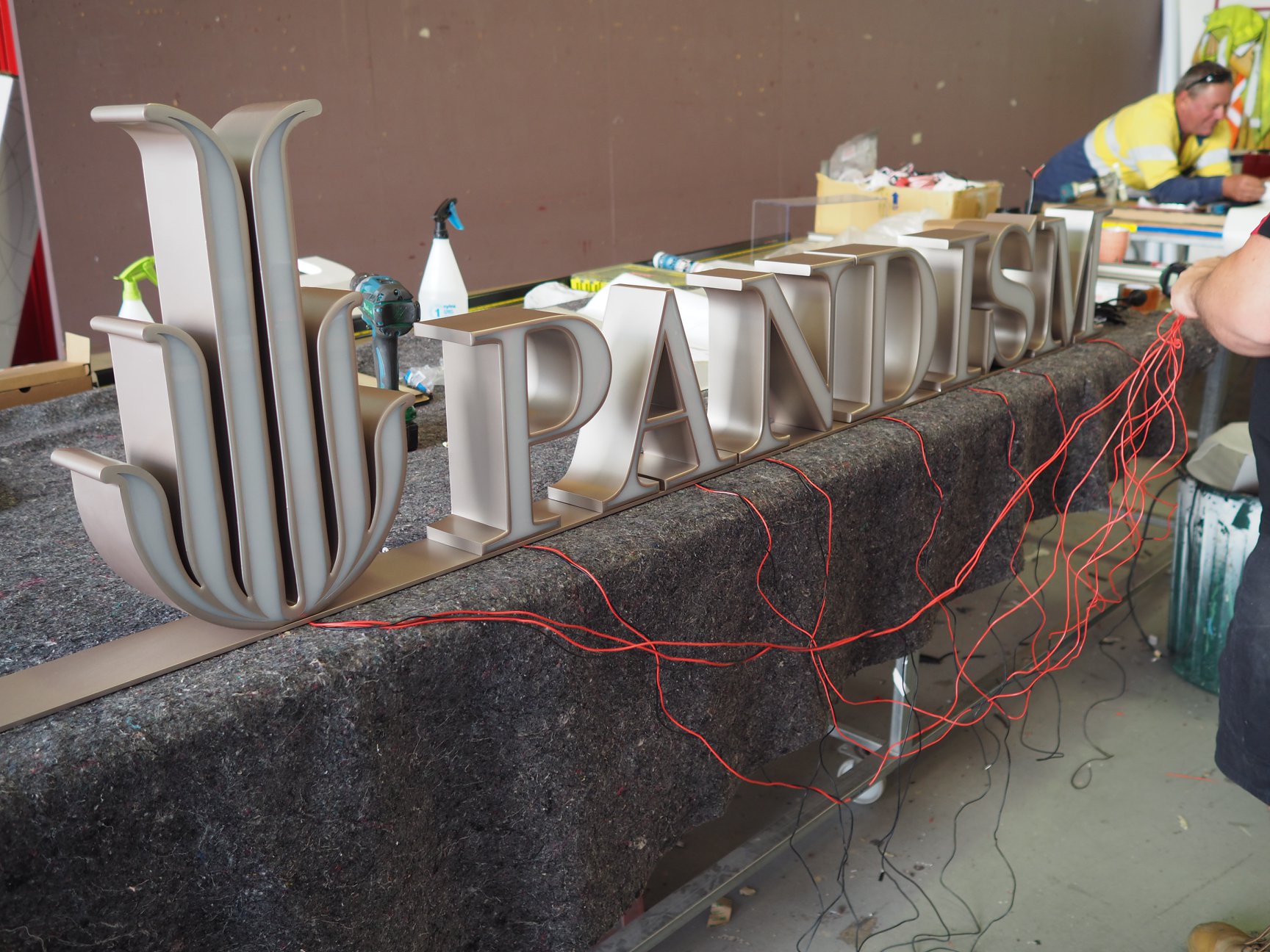 Installing custom lettering signage for Pandism