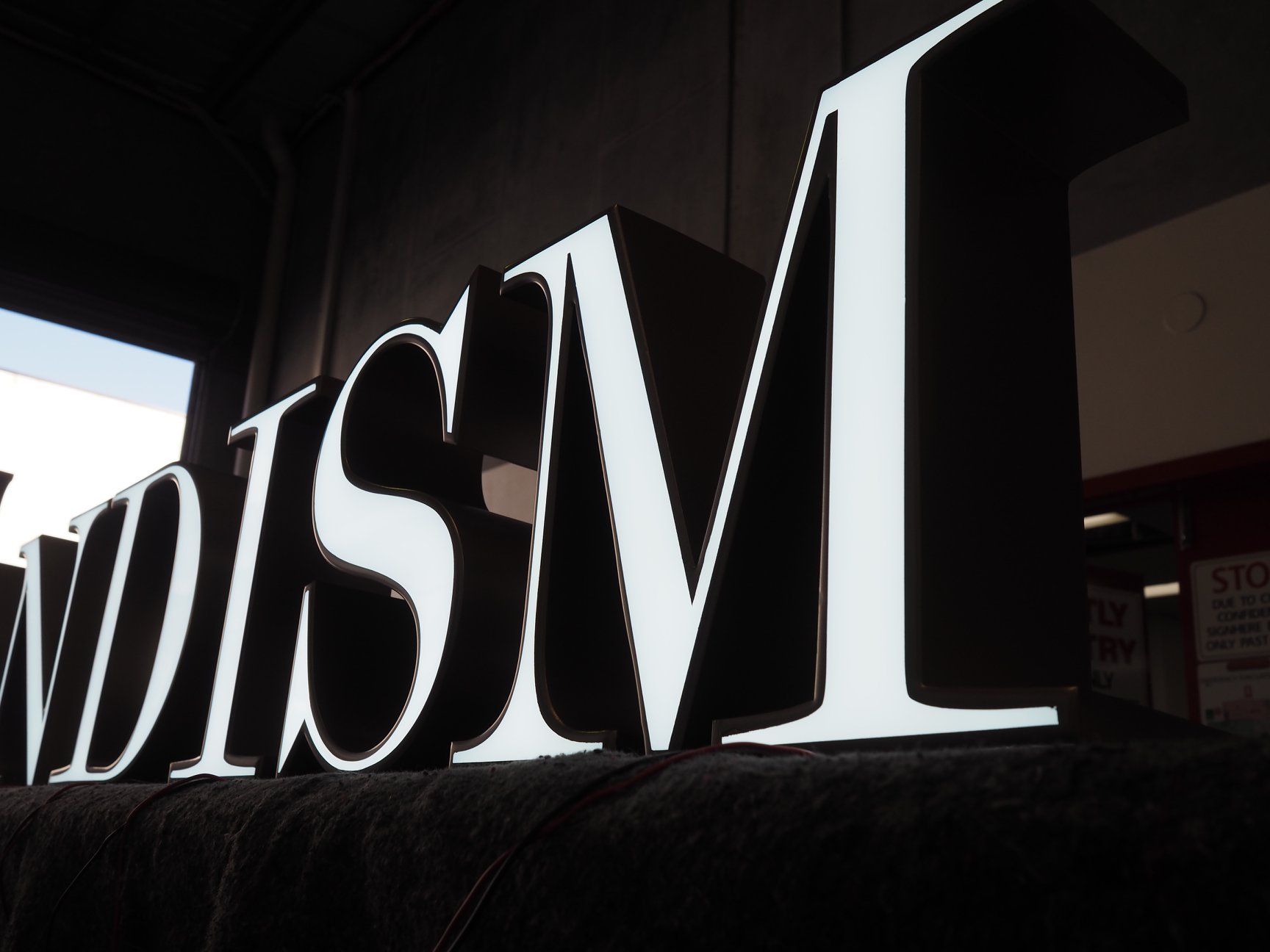 Close-up view of custom illuminated logo for Pandism.