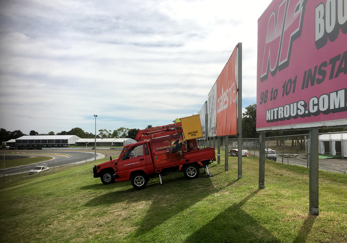 Installing the new billboard for Mrs Mac's at Barbagello Raceway