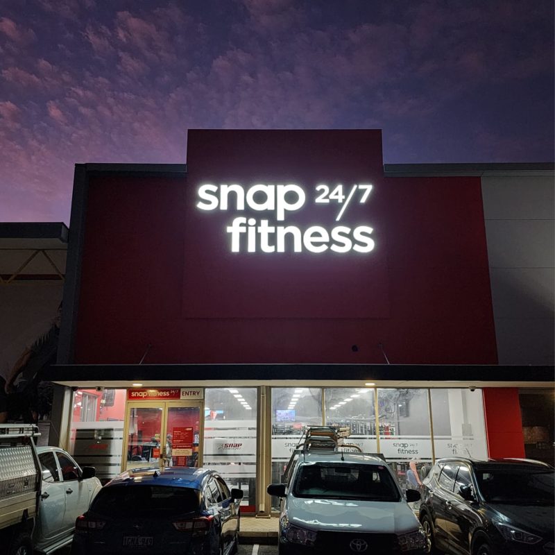 Exterior of Snap Fitness Redcliffe at dusk. The logo is illuminated.